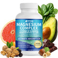 Supplement bottle labeled 'Magnesium Complex' with health foods like avocado, grapefruit, and nuts on a white background.